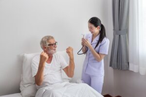 A nurse is cheering up a patient