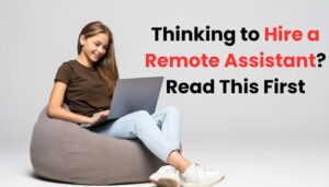 Smiling young woman sitting on a bean bag working on a laptop, with the text 'Thinking to Hire a Remote Assistant? Read This First' displayed beside her