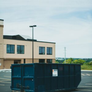 20-yard roll-off dumpster from Liberty Hauling Services parked in a driveway, ready for waste disposal from a home renovation project in Central Florida.