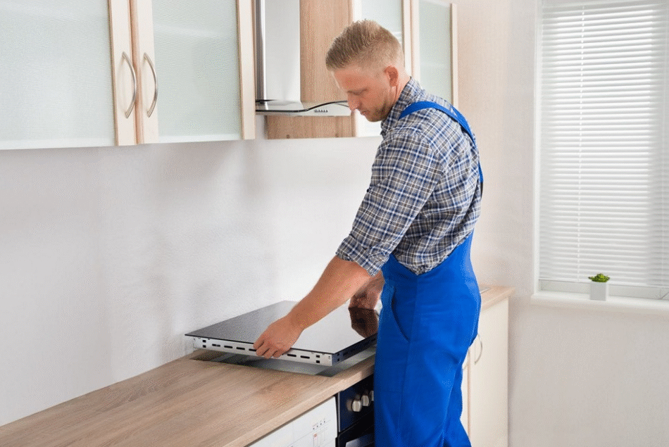 cooker technician installing or repairing a cooker in a Dubai kitchen.
