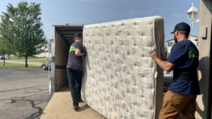 Professional team loading an old mattress into a truck as part of Mattress Removal Services Kent WA, ensuring safe and eco-friendly disposal.