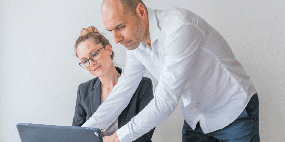 two-businesspeople-using-laptop-office