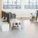 Modern open-plan office furniture warehouse setup with workstations, ergonomic chairs, and collaborative corner office desk spaces.