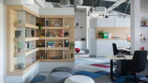 Modern office furniture setup with ergonomic chairs, wooden shelving, and stylish workspace design in a contemporary office interior.