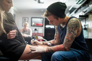 Tattoo artist creating detailed custom ink in tattoo studio Croydon
