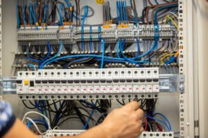 Professional electrician performing electrical installations in a commercial building
