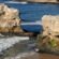 Sea stacks and a natural rock arch with cormorants at Natural Bridges State Beach near Santa Cruz, California