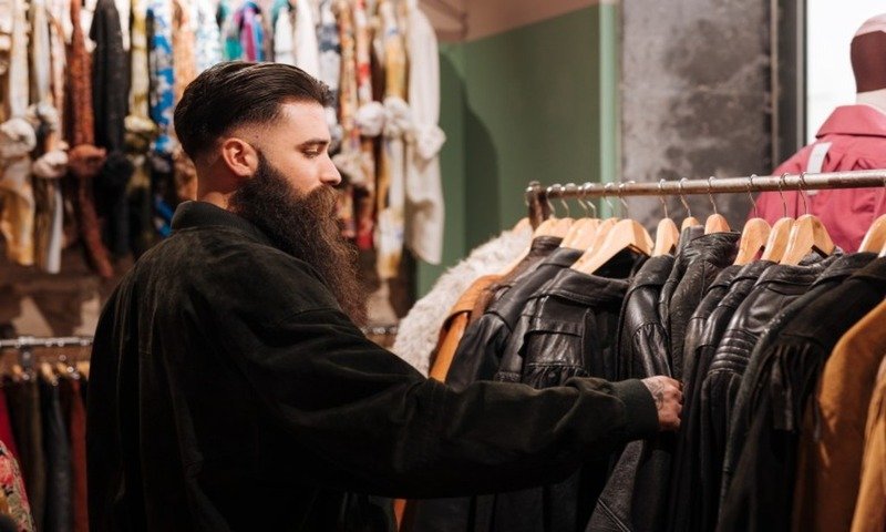close up man looking leather jacket rail