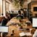 Open-plan modern coworking office space in Brisbane featuring warm lighting, timber desks, and natural foliage
